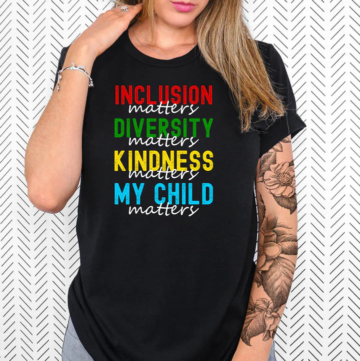 a woman wearing a black t - shirt with a rainbow message