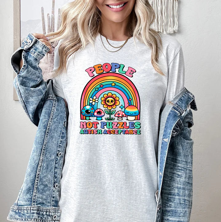 a woman wearing a white t - shirt with a rainbow design