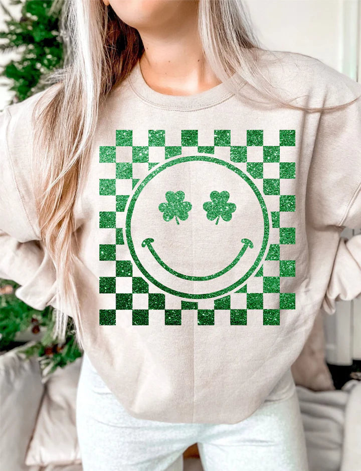 a woman wearing a sweatshirt with a green smiley face on it
