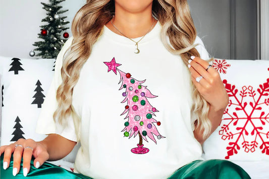 a woman sitting on a couch with a christmas tree on her shirt