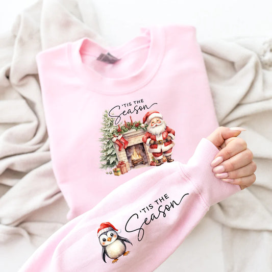 a person holding a pink shirt with a penguin on it