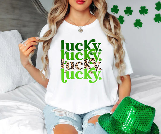 a woman sitting on a bed wearing a t - shirt that says lucky lucky lucky