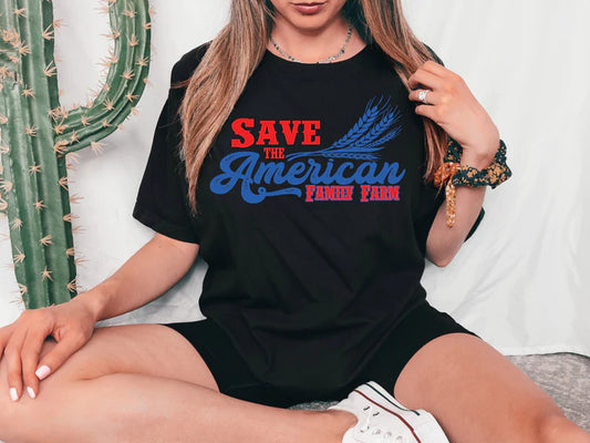 a woman sitting on a bed wearing a black t - shirt that says save the