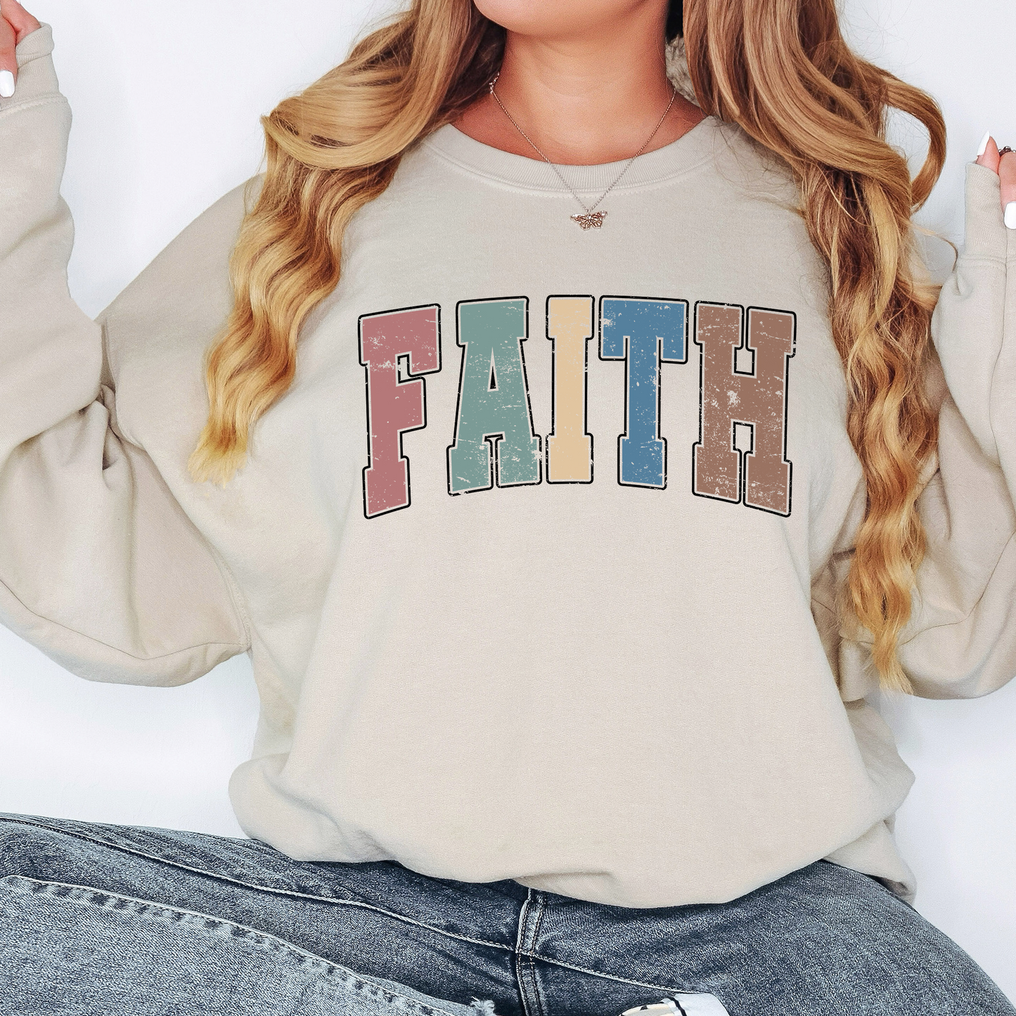 a woman wearing a sweatshirt that says faith