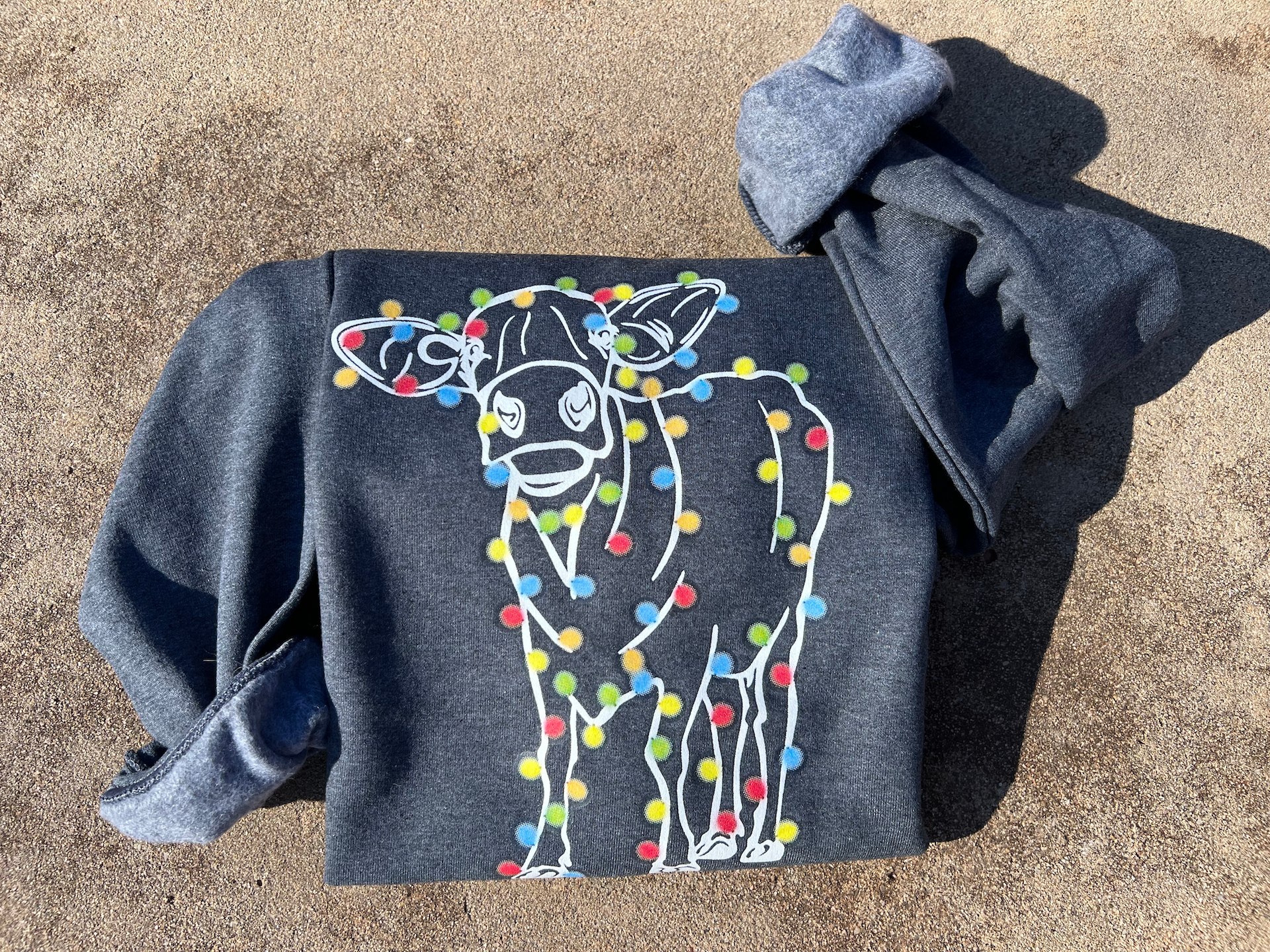 a sweater with a picture of a cow on it