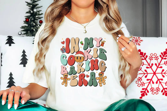 a woman sitting on a couch wearing a christmas t - shirt