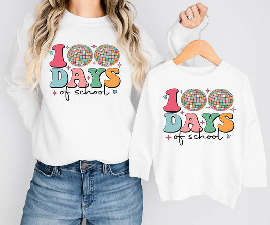 a woman wearing a white shirt with the words 100 days of school on it