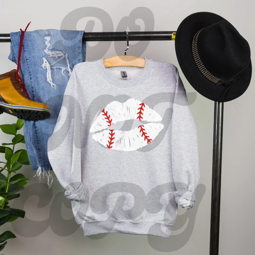 a baseball sweater hanging on a rack next to a hat