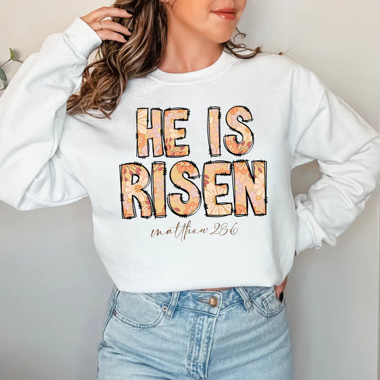 a woman wearing a sweatshirt that says he is risen