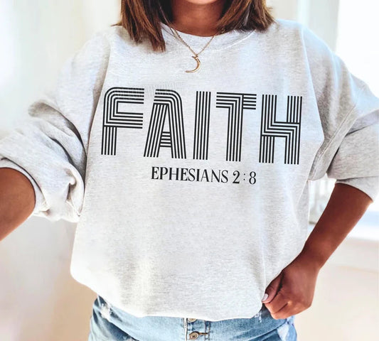 a woman wearing a sweatshirt that says faith