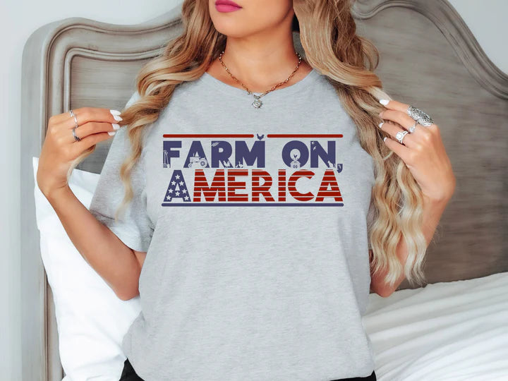 a woman standing in front of a bed wearing a t - shirt that says farm