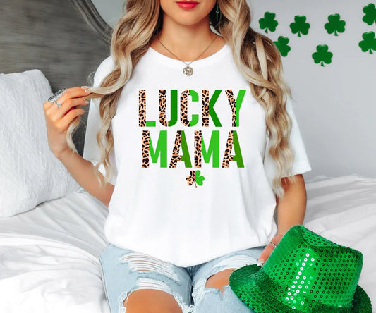a woman sitting on a bed wearing a lucky mama shirt