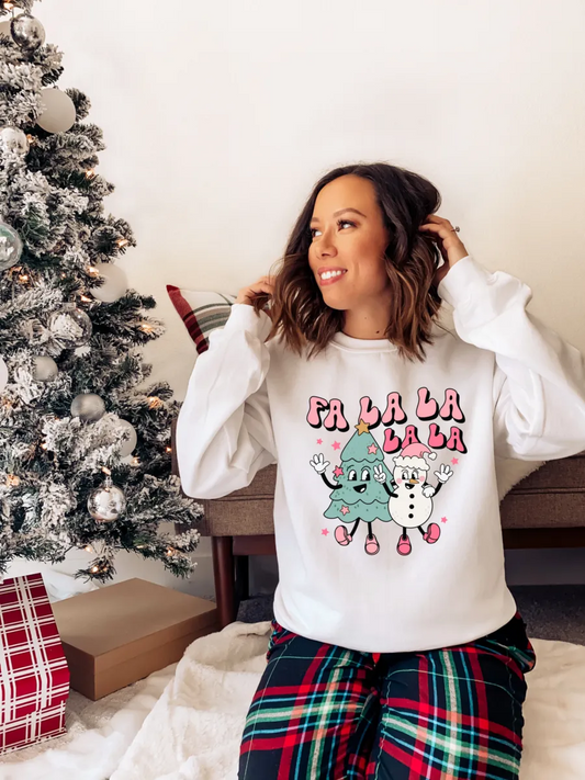 a woman sitting in front of a christmas tree