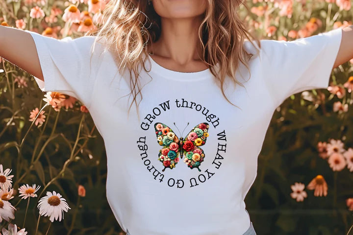 a woman standing in a field of flowers