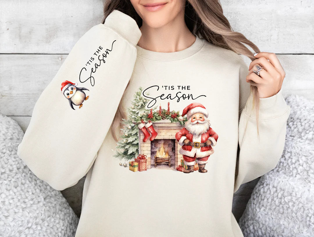 a woman wearing a sweatshirt with a christmas scene on it