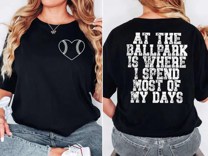 a woman wearing a black shirt that says at the ballpark is where i spend