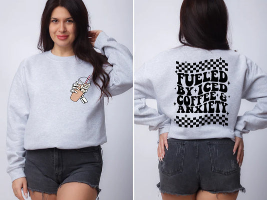 a woman wearing a sweatshirt that says fueled by iced coffee